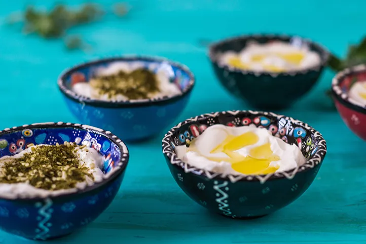 Several bowls of Laban with various toppings