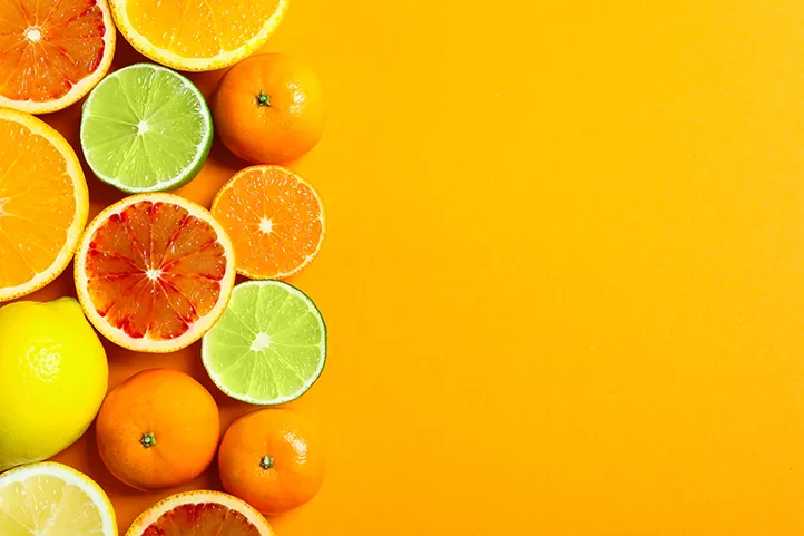 Slices of citrus fruits on yellow background